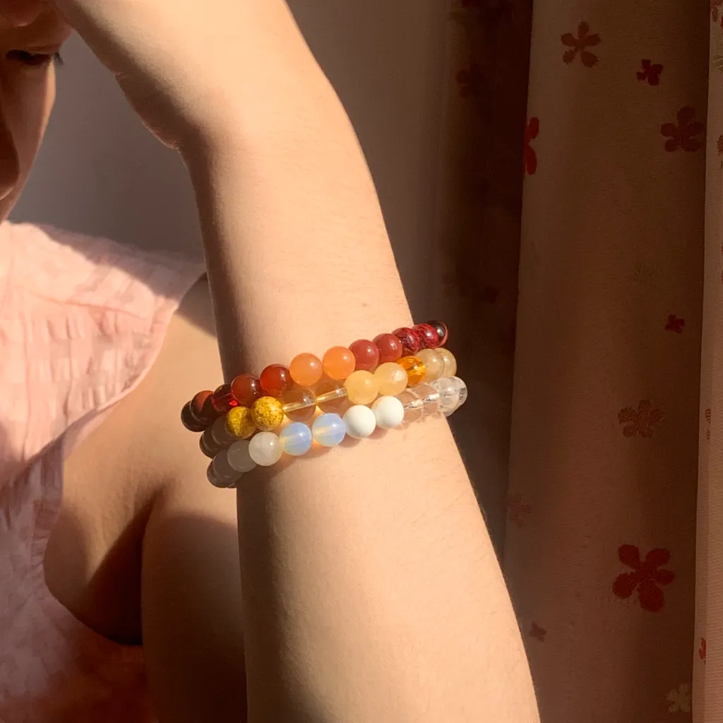 Earth Element Bracelet layered with Metal Element Bracelet and Fire Element Bracelet on the wrist — a stacked everyday styling