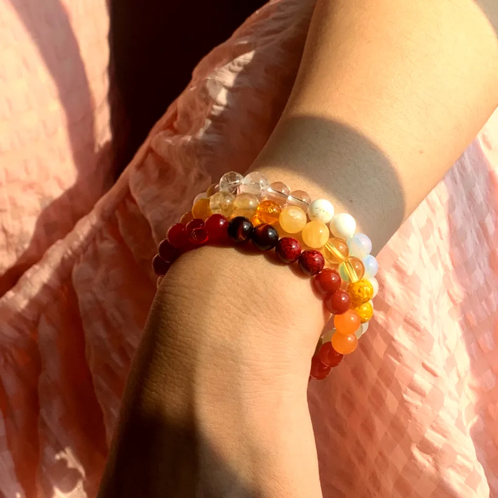 Metal Element Bracelet Layered Earth Element Bracelet and Fire Element Bracelet on the wrist — a stacked everyday styling