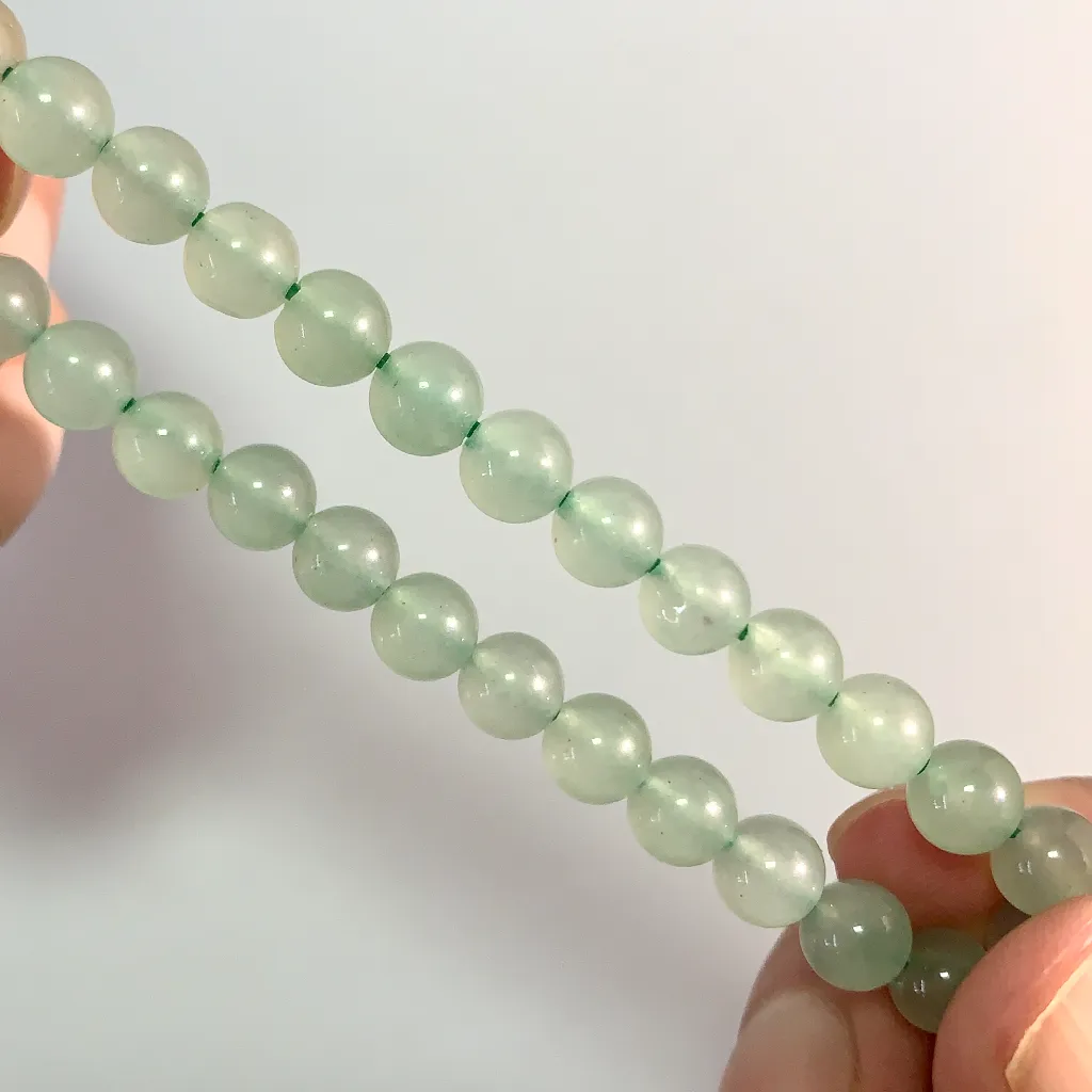 Close-up of green aventurine bracelet beads and stringing