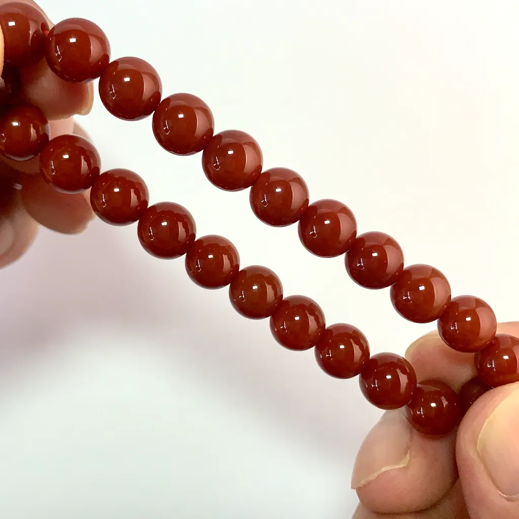 Close-up of South Red Agate Bracelet 8mm beads and elastic cord