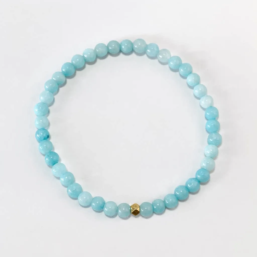 Aquamarine bracelet — front view, translucent blue aquamarine beads on white background