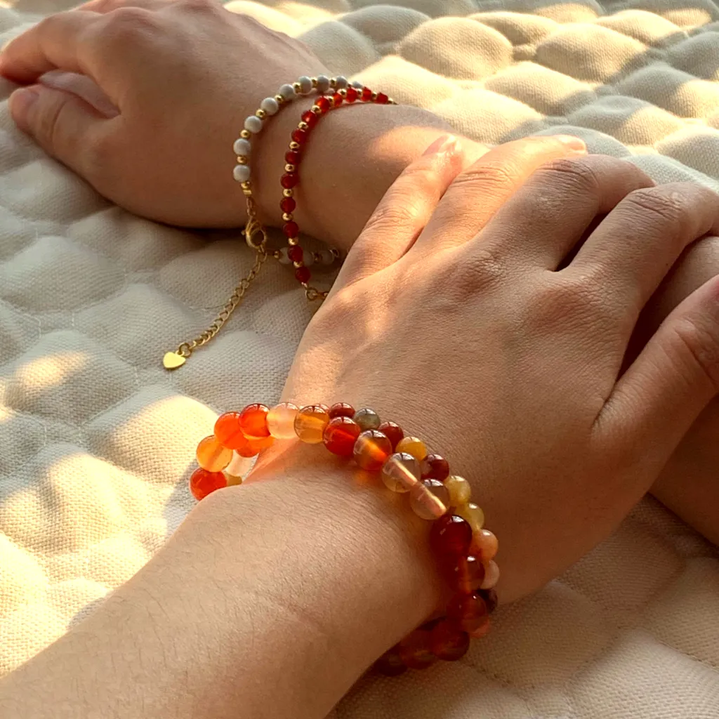 Carnelian bracelet layered with Howlite Bracelet on the wrist — a stacked everyday styling
