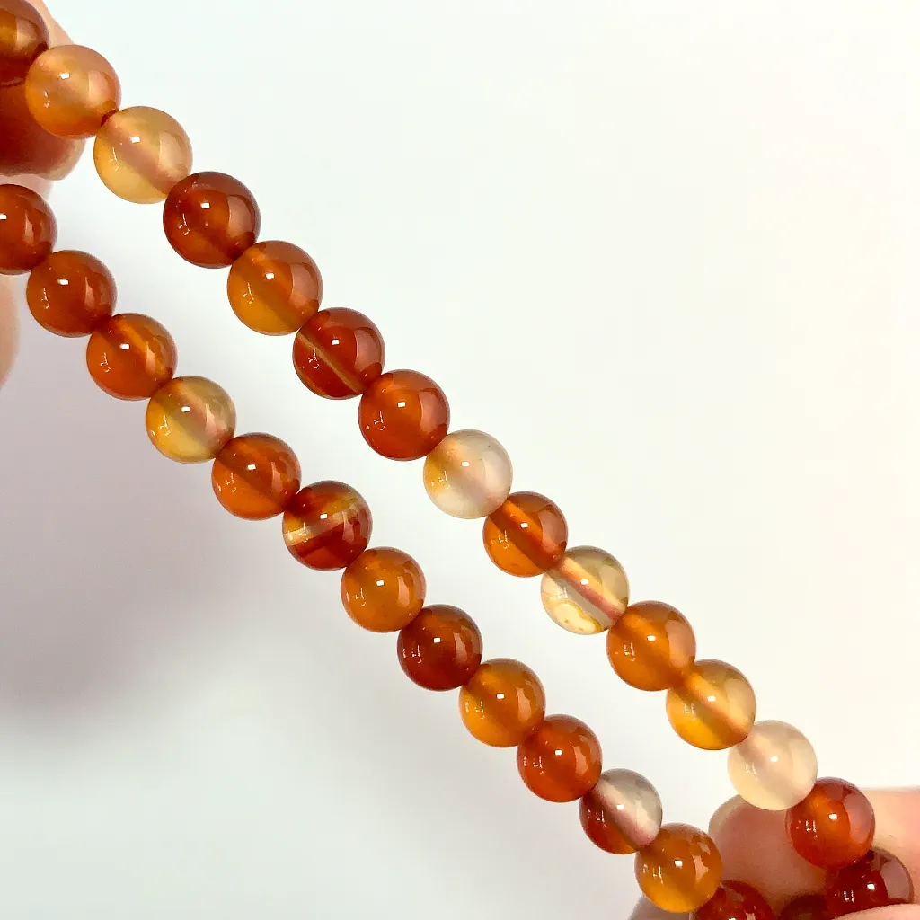 Red Agate Bracelet detail — natural red, orange, and cream banding